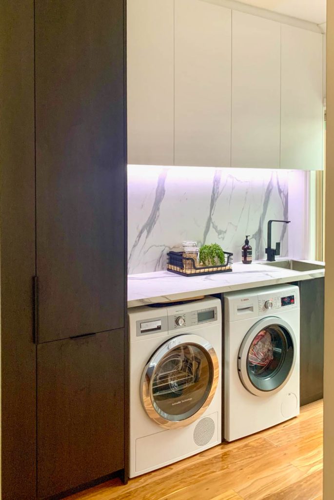 Laundry fitout with tall storage and pull-out hamper