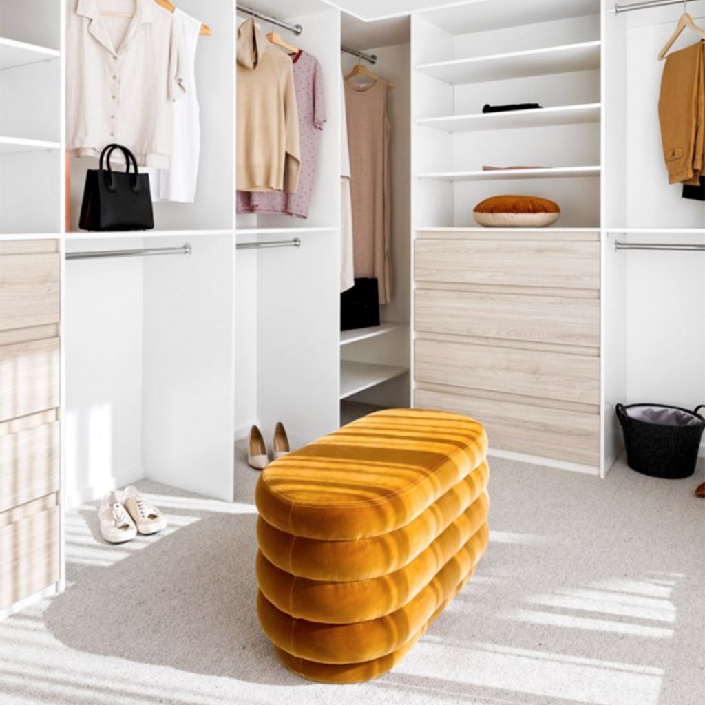 Custom walk-in robe with timber shelving and hanging space