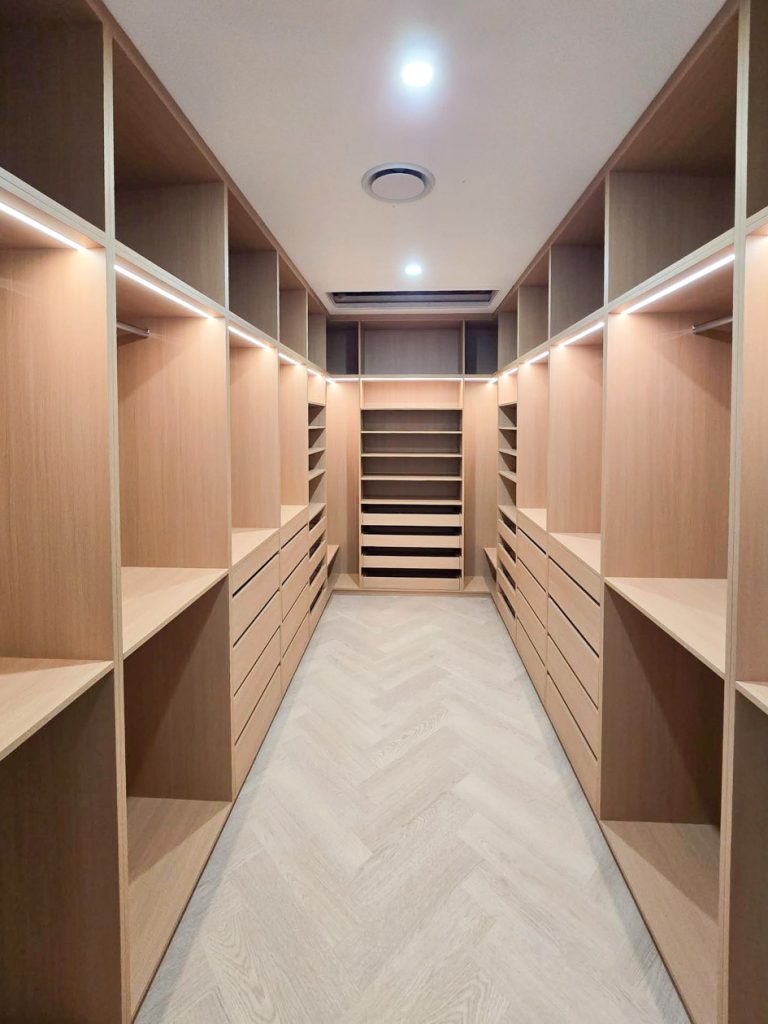 Custom walk-in robe interior with accessory storage